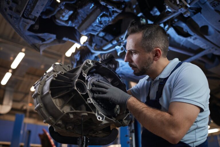 A professional diesel mechanic inspects a high-performance truck engine.